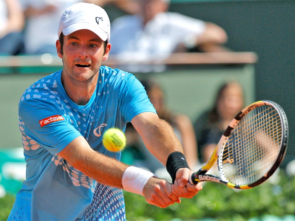 Brian Baker in action against Gilles Simon at the French Open