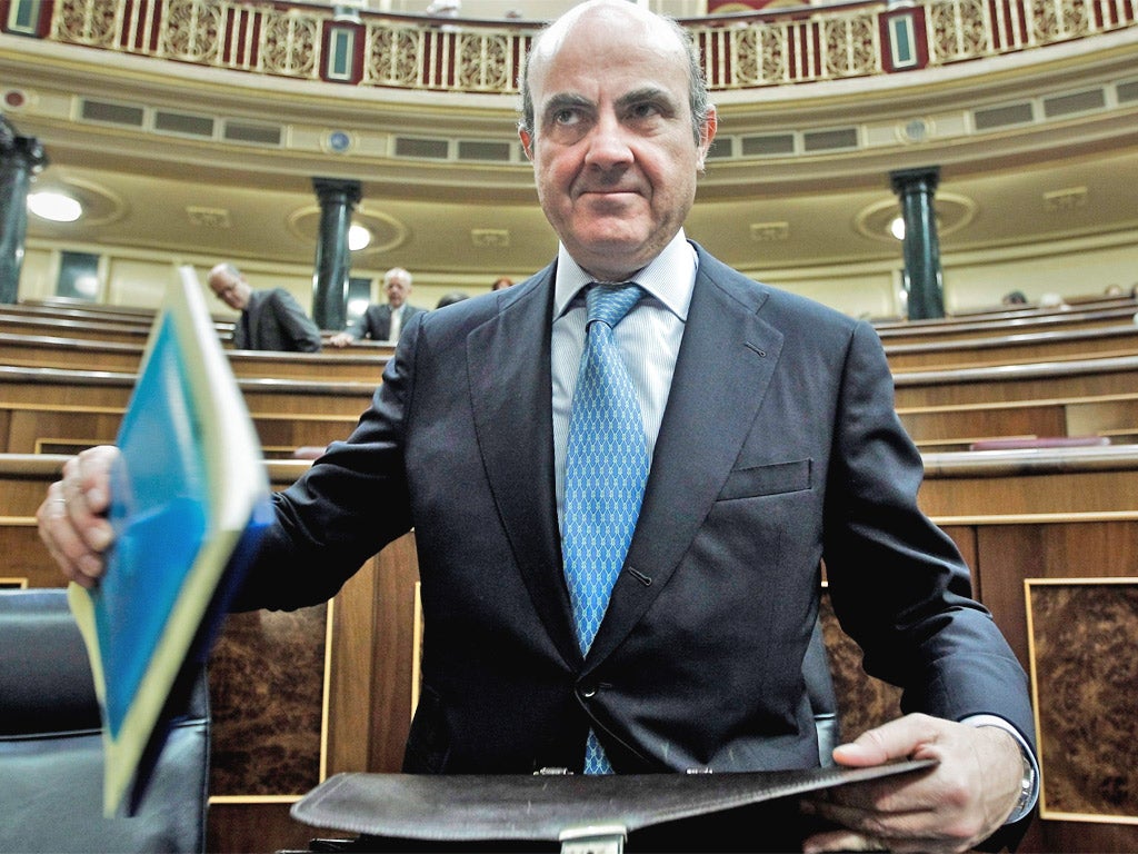 A grim-faced Luisde Guindos, Spain's Economy Minister, at the parliament in Madrid yesterday