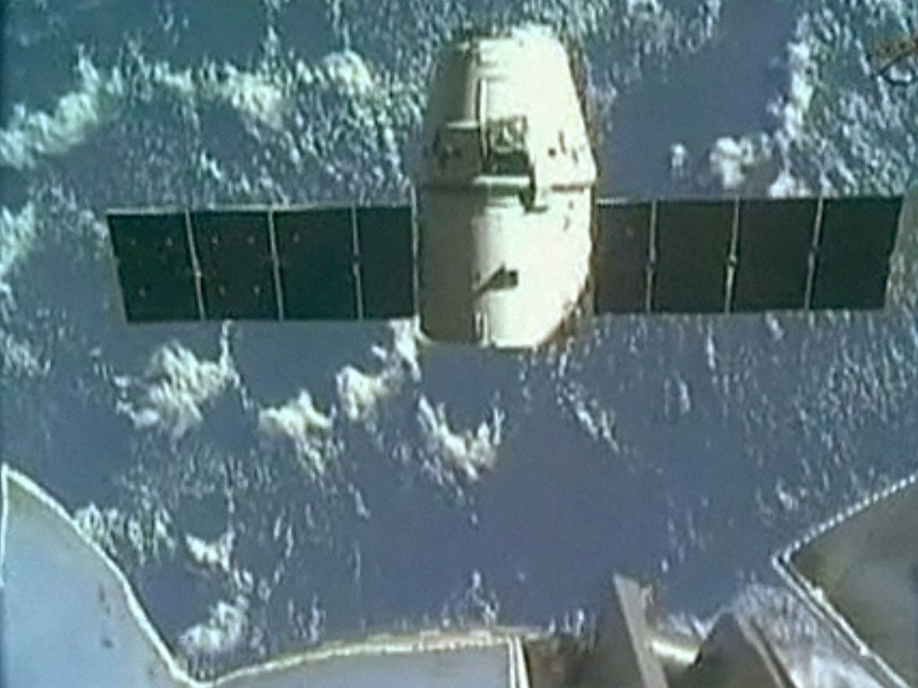 In this frame grab from a NASA video, the SpaceX Dragon capsule is seen moving away from the International Space Station. The Dragon cargo vessel was released by the robotic arm of the ISS early Thursday at the start of its return to Earth from an histori
