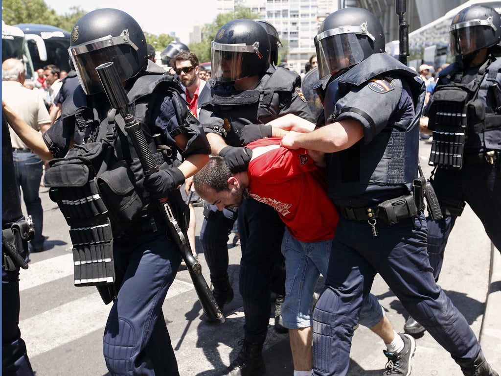 Spanish police arrest a demonstrator during a anti-austerity protest in Madrid yesterday