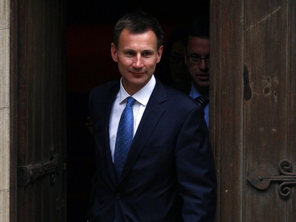 Britain's culture secretary Jeremy Hunt leaves the High Court after giving evidence at the Leveson Inquiry