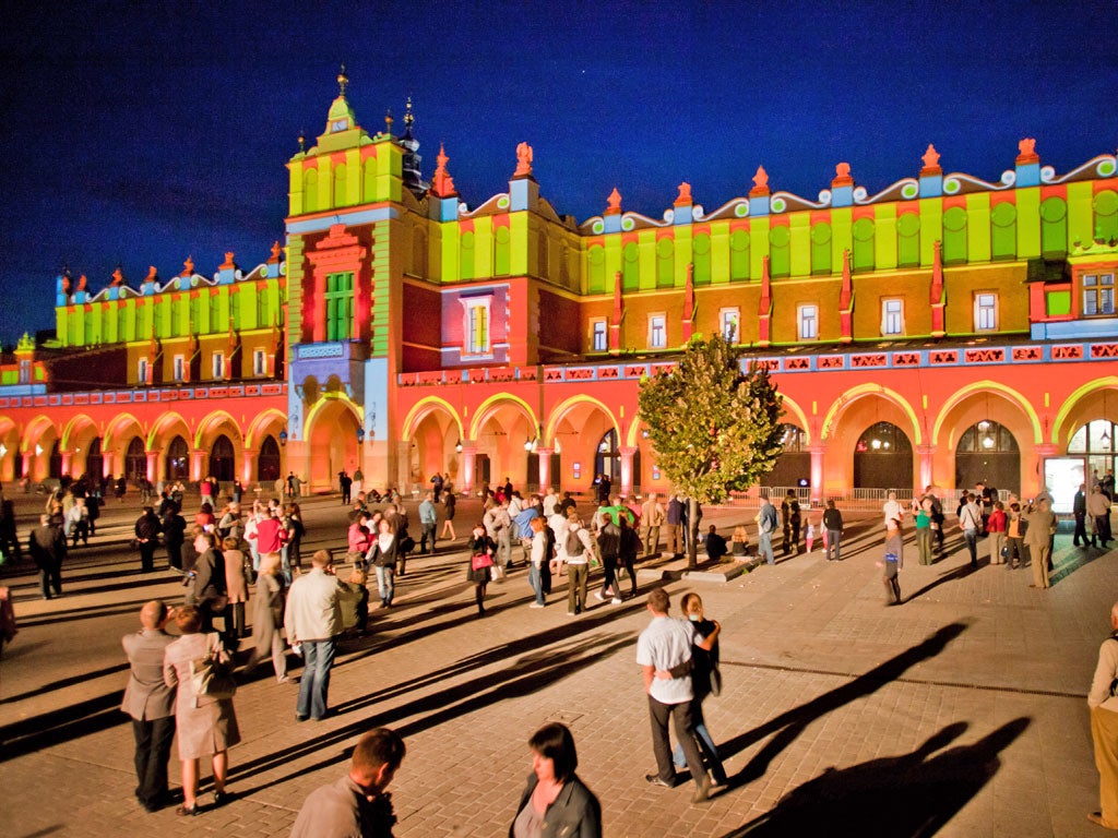 A cloth facade of medieval halls is illuminated in Krakow's Market Square