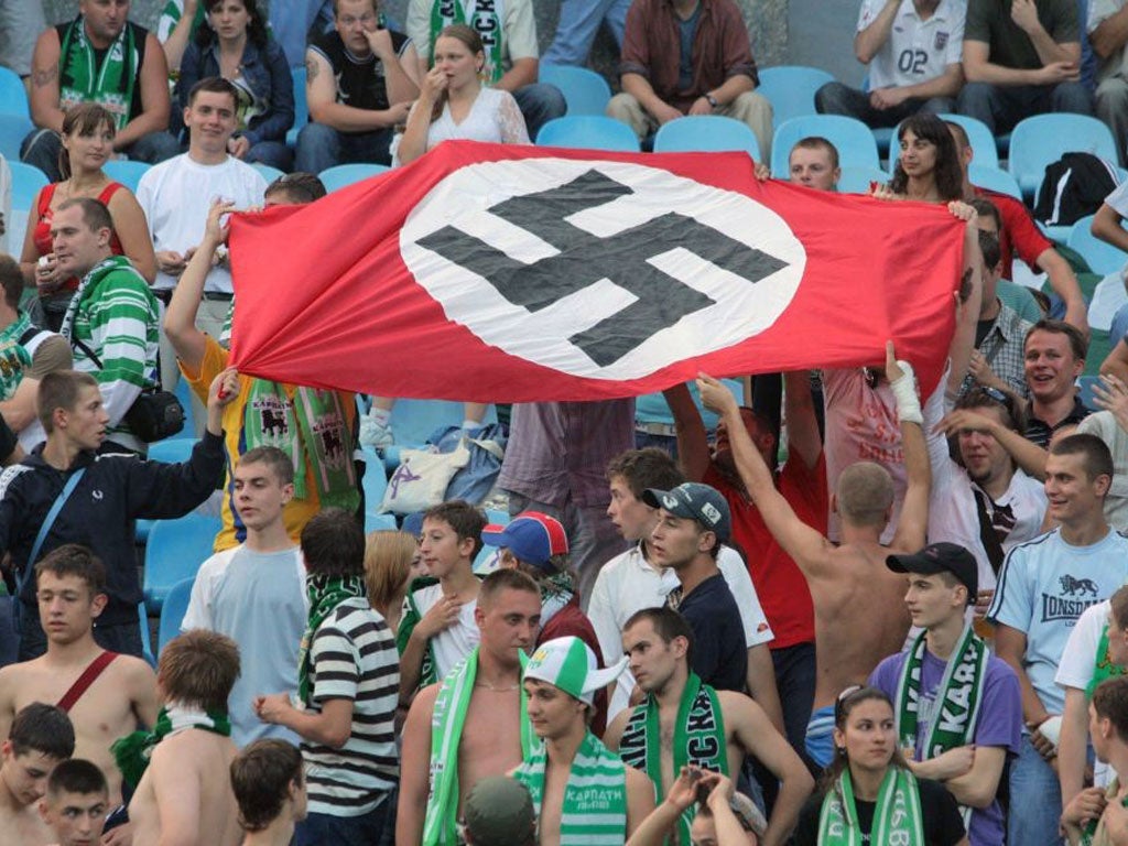 Fans display a Nazi flag during a league game in Ukraine, co-host of Euro 2012 this summer