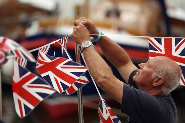A man put up bunting in preparation for the Jubilee