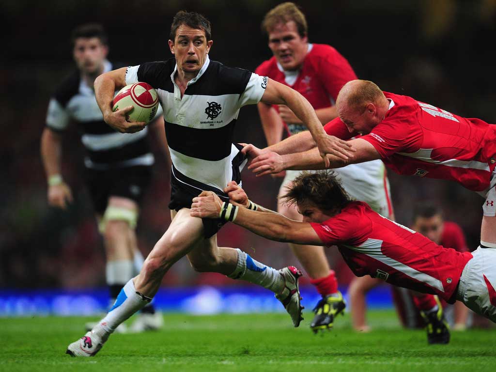 Old hands: Shane Williams is tackled by Martyn Williams (middle right)