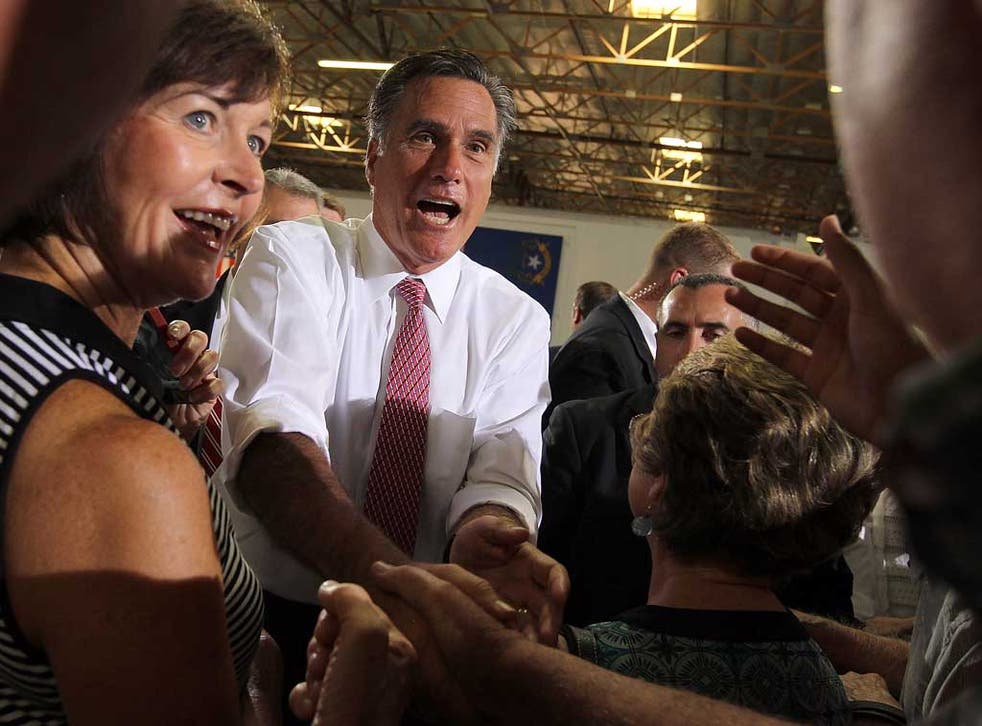 On the up: Mitt Romney and supporters at a campaign rally in Las Vegas last week