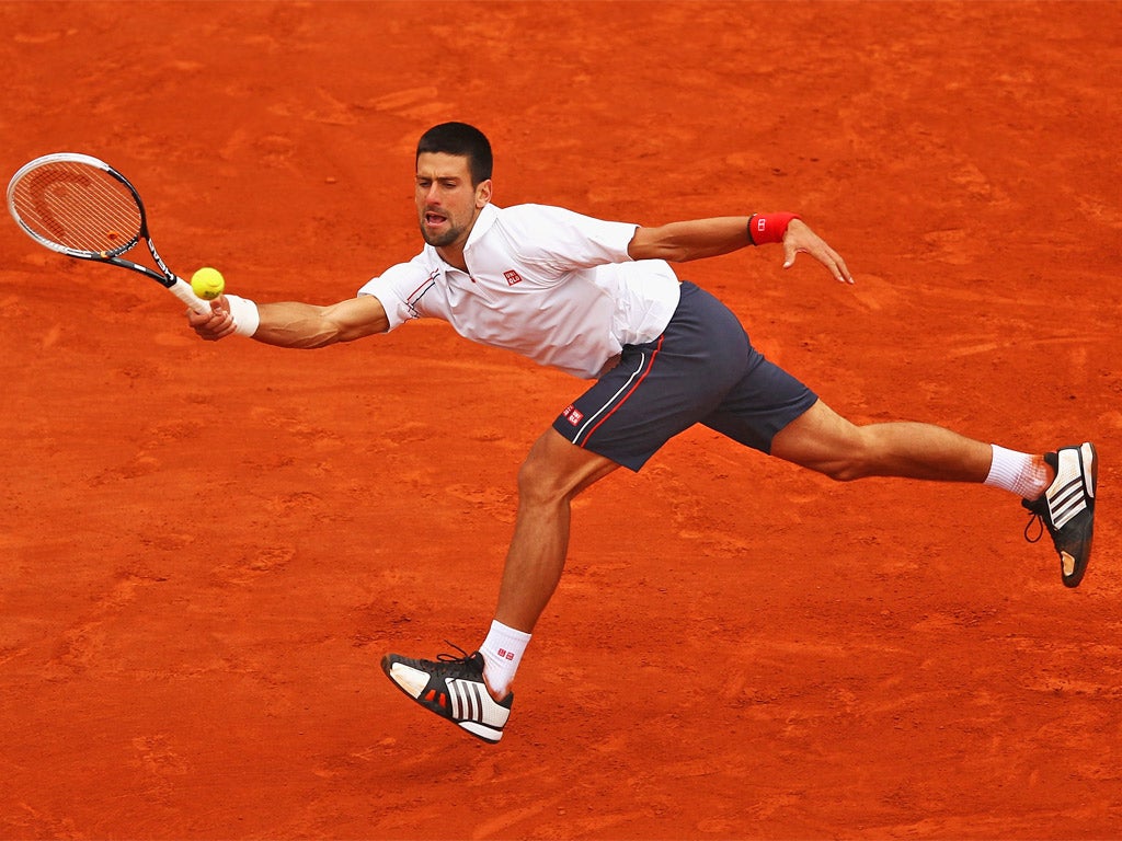 Novak Djokovic stretches for a forehand during his five-set win over Jo-Wilfried Tsonga last night