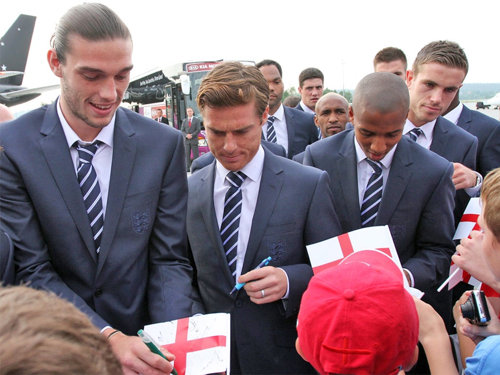 England players sign autographs for fans at the Balice airport in Krakow