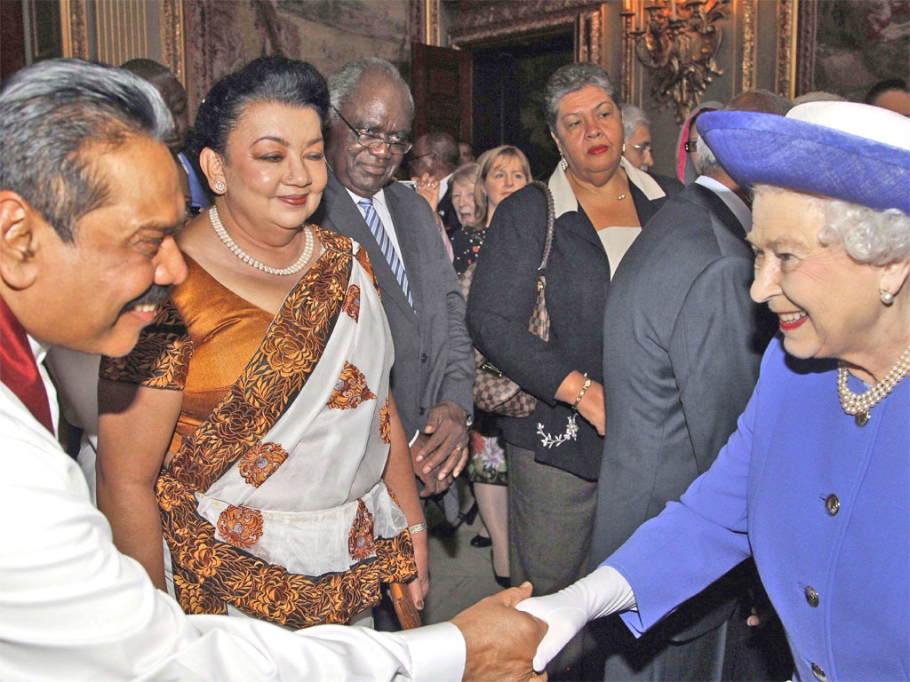 'And what do you do?': Sri Lankan President Mahinda Rajapaksa, whose troops are accused by the UN of killing thousands of civilians, meets the Queen for her Commonwealth lunch, while protesters rally outside on Pall Mall