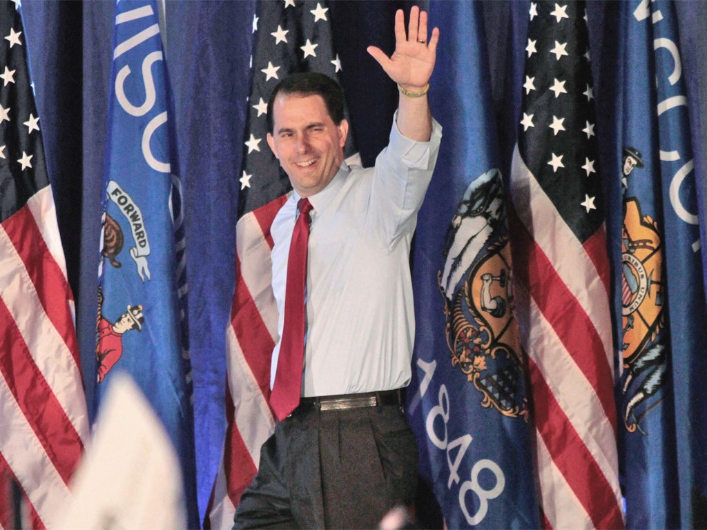 Republican Governor Scott Walker celebrates his clear victory on Tuesday over his Democrat rival Tom Barrett in the recall election in Wisconsin