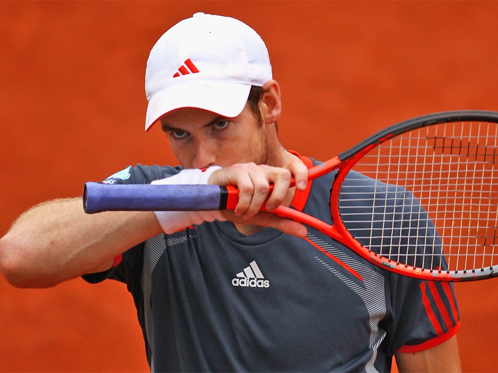 Andy Murray looks dejected as defeat looms at Roland Garros yesterday