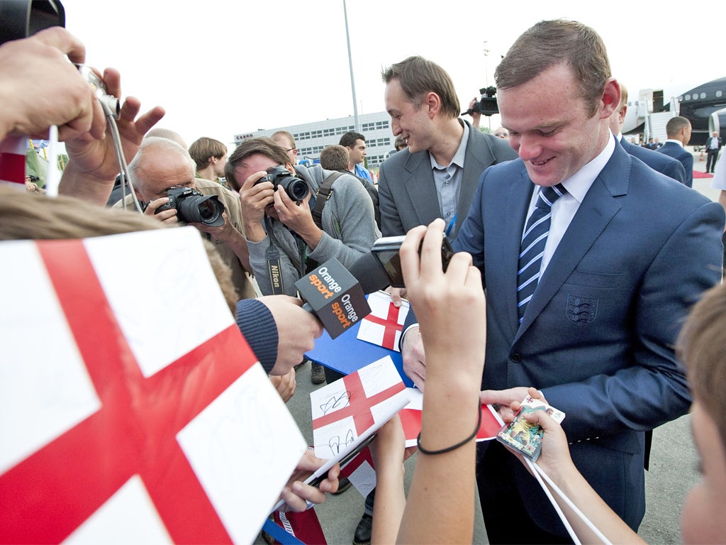 Rooney signs autographs at Krakow Airport yesterday