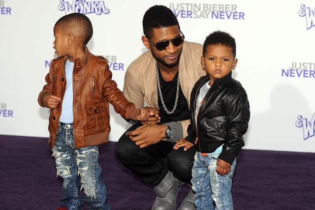 Father figure: Usher arrives with his children at the premiere of Justin Bieber's 3-D concert film 'Never Say Never' in Los Angeles in 2011