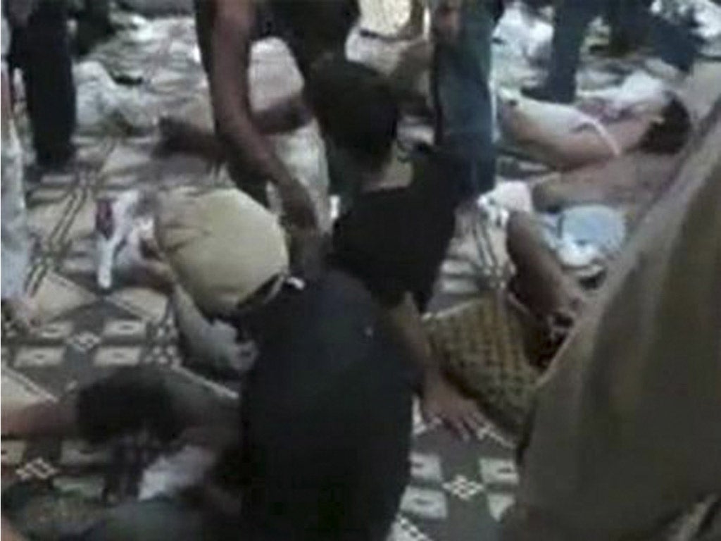 Bodies of the massacred lie in Qubair