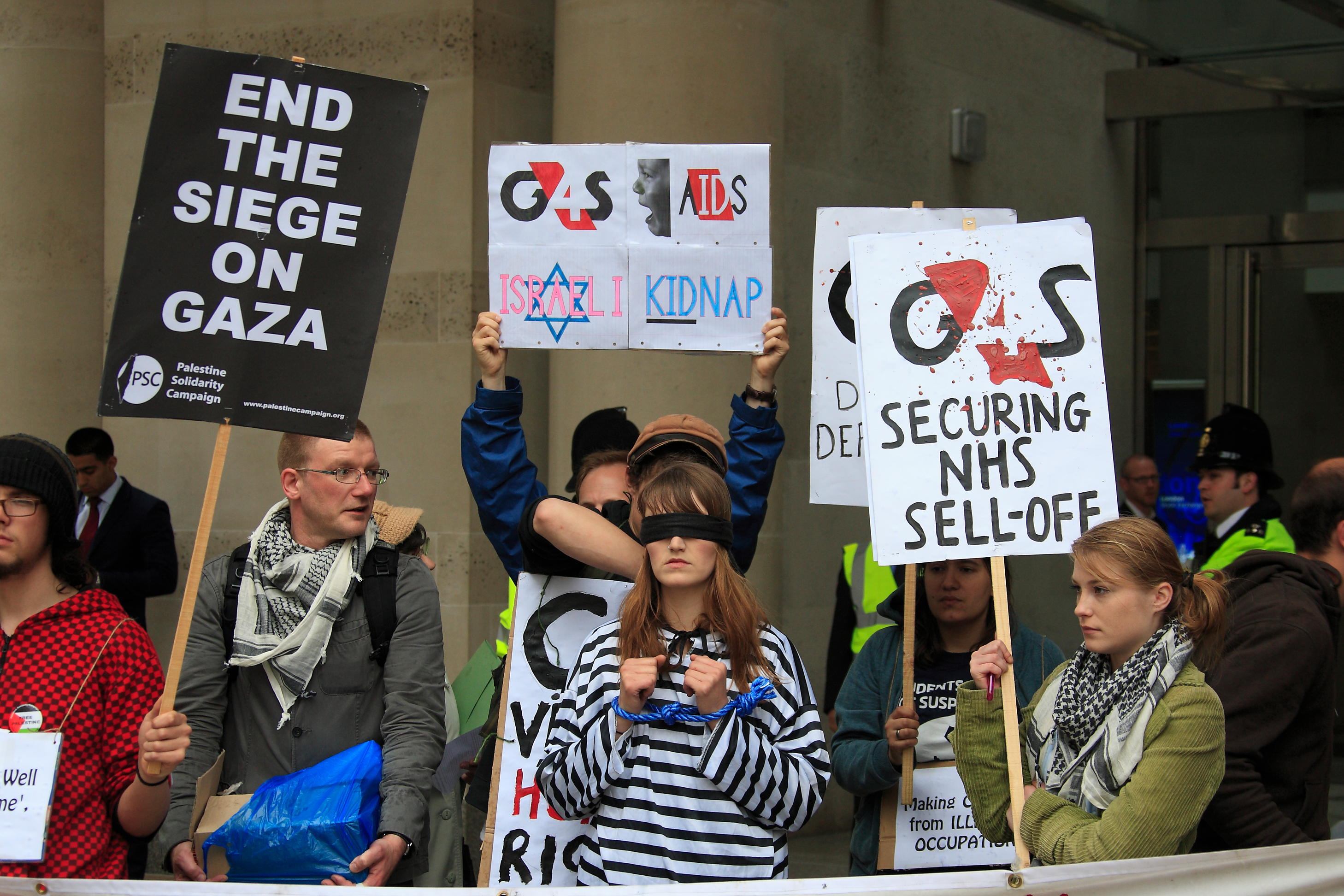 Activists protest against G4S outside the London Stock Exchange yesterday
