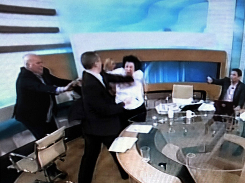 Ilias Kasidiaris of the Golden Dawn party strikes Liana Kanelli, a female MP for the Greek Communists during a live broadcast