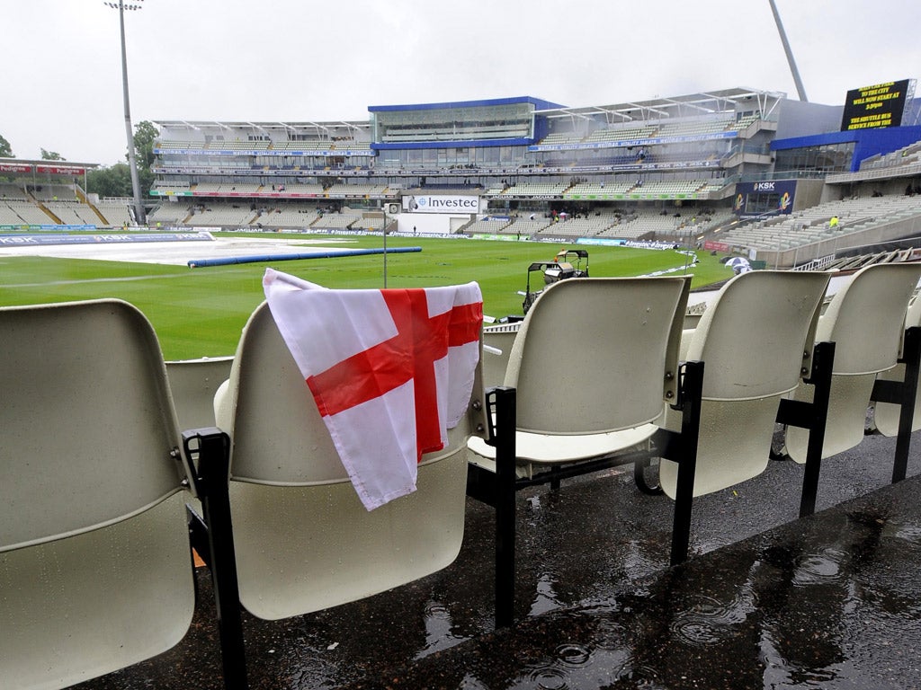 A lone St George's flag as heavy rain prevents any play on day one