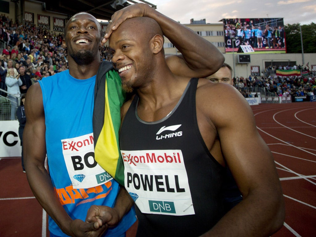 Usain Bolt pats Asafa Powell on the head after edging him out in the 100m in Oslo