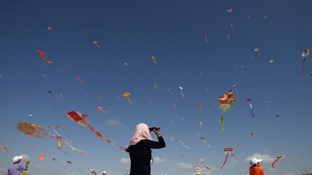 Palestinian children fly kites in the town of Beit Lahiya