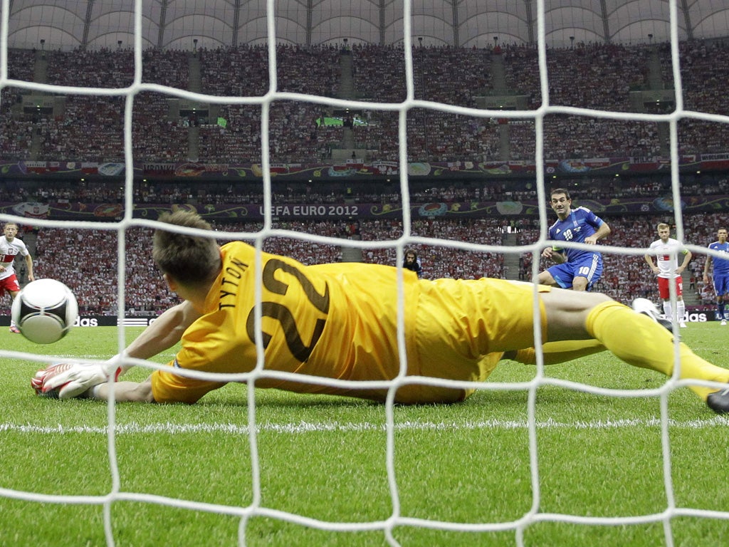 Polish goalkeeper Przemyslaw Tyton saves a penalty during a match with Greece
