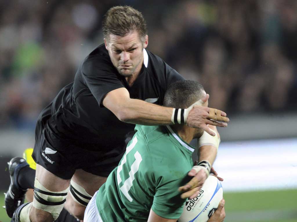 All Black attack: Richie McCaw tackles Simon Zebo of Ireland at Eden Park