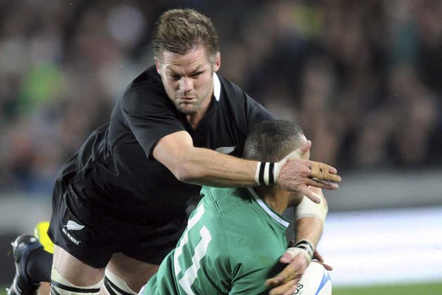 All Black attack: Richie McCaw tackles Simon Zebo of Ireland at Eden Park