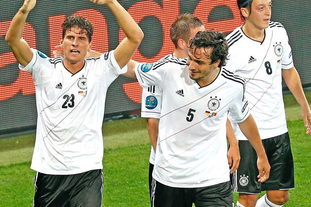 Mario Gomez (left) is congratulated by his German team-mates for scoring the winner against Portugal on Saturday night