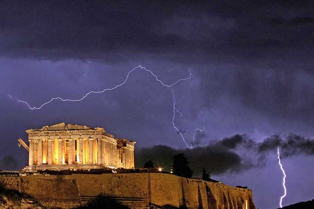 The Parthenon temple, on the Acropolis hill in Athens, is framed by lightning bolts