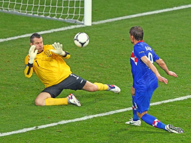 Croatia's Nikica Jelavic scores the 2-1 lead against Ireland goalkeeper Shay Given during the Group C preliminary round match of the UEFA Euro 2012