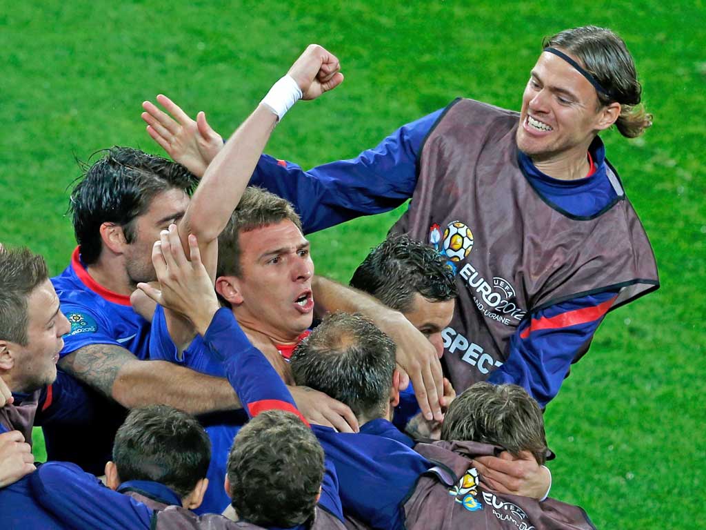 Mario Mandzukic celebrates with the Croatia team after his
early goal