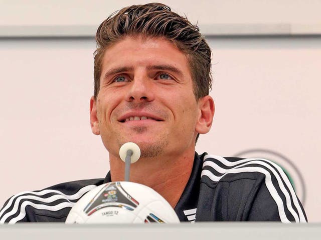 Mario Gomez is all smiles during a press conference for
tomorrow’s game with the Netherlands