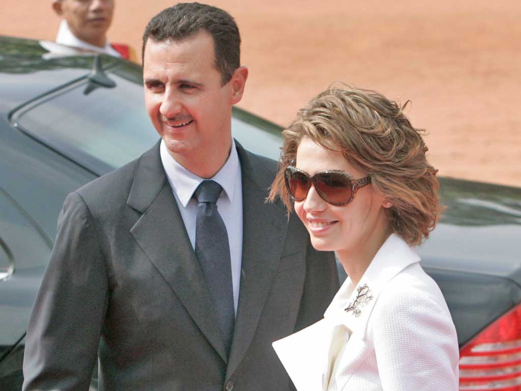 Syrian President Bashar al-Assad, left, and his wife Asma Assad