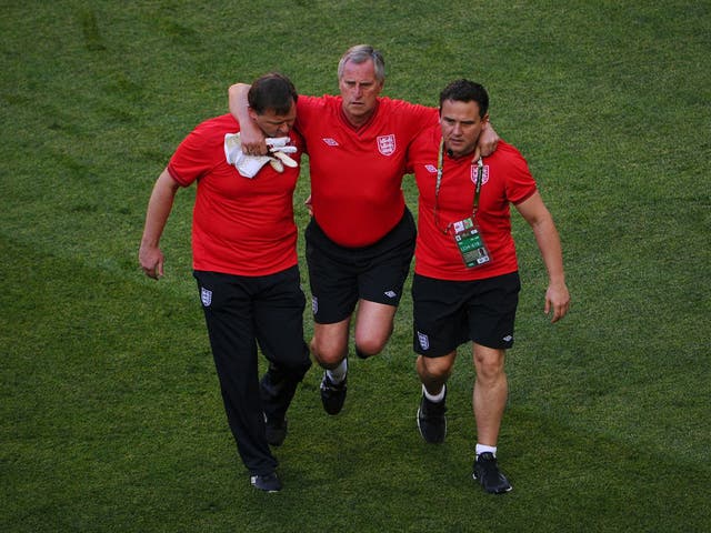 Ray Clemence is forced off the pitch