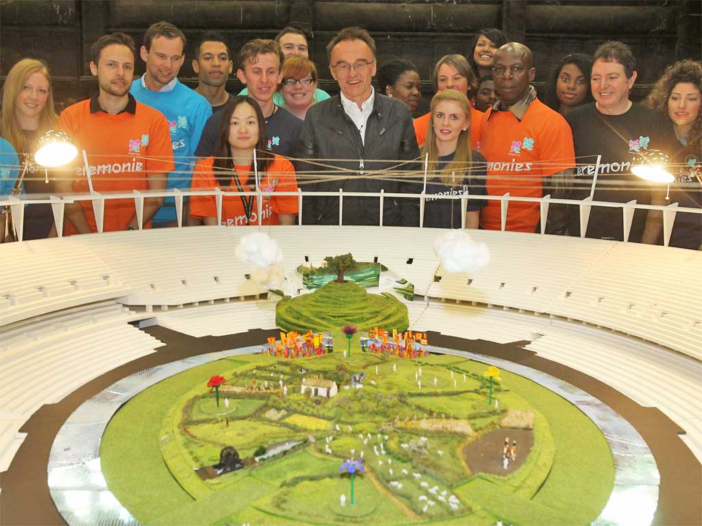 Danny Boyle, with London 2012 crew and volunteers, unveils a model of the Opening Ceremony yesterday
