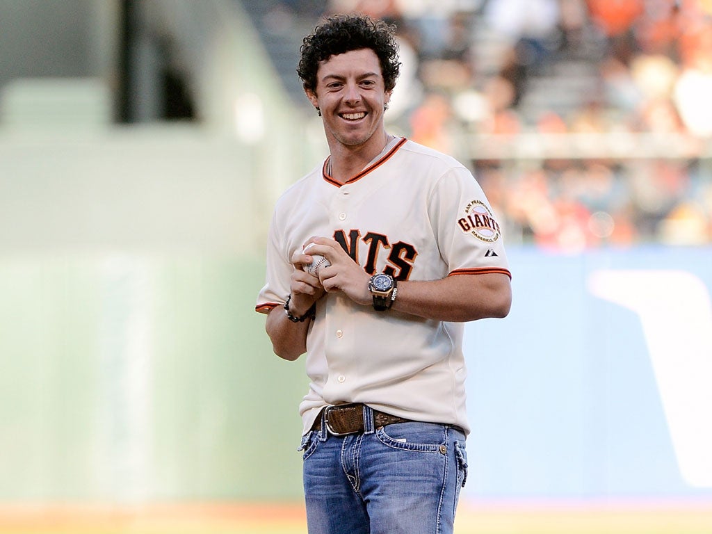 Rory McIlroy throws the first ball for the Giants