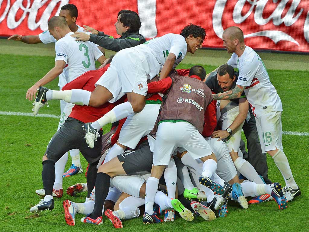 Portuguese players celebrate after Varela scored a dramatic late winner