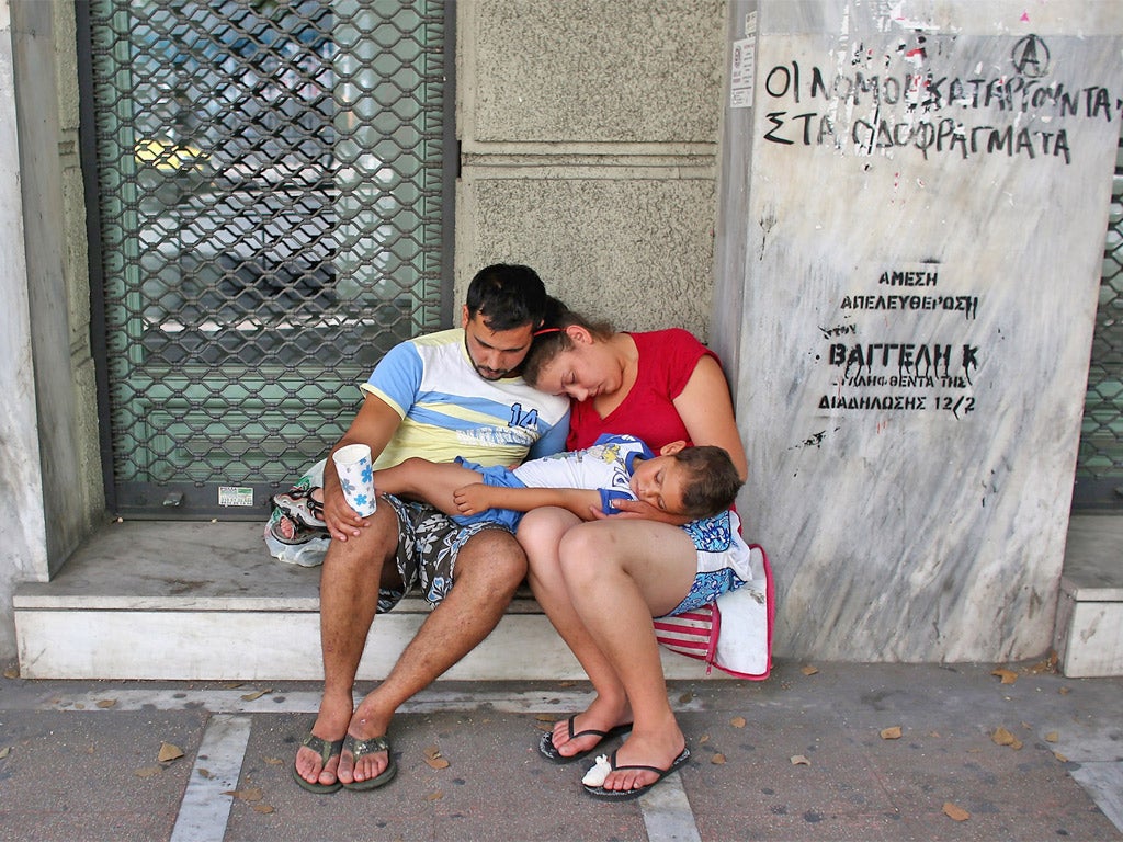 A family beg on the street in Athens yesterday as the country’s cash crisis continues to bite
