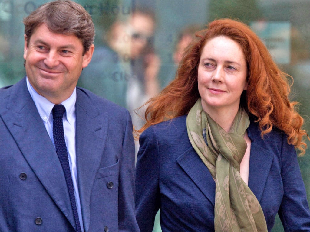 Rebekah and Charlie Brooks leave the court yesterday