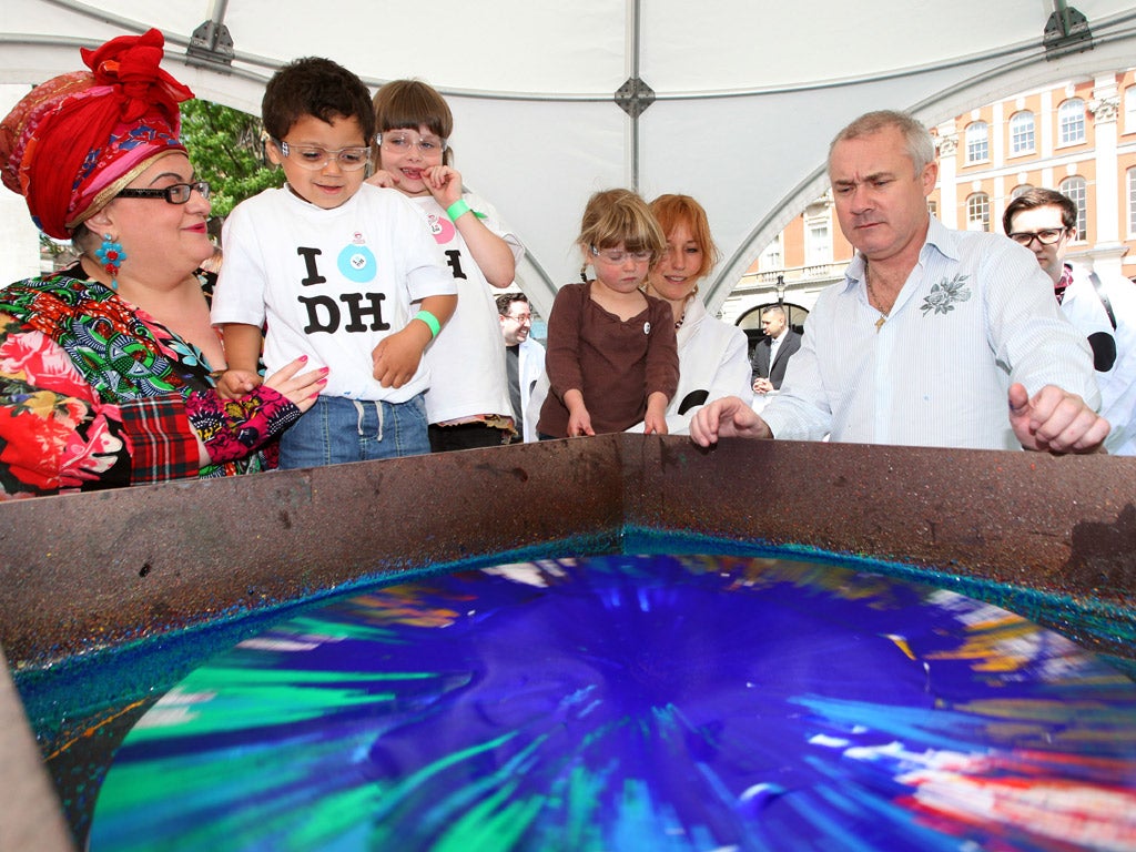 Damien Hirst with Kids Company's founder Camilla Batmanghelidjh and children spin-painting in Covent Garden