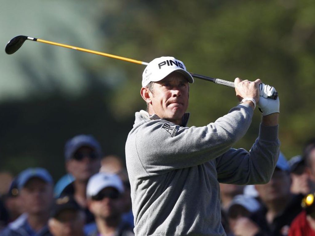 Lee Westwood watches his tee shot on the 10th hole yesterday