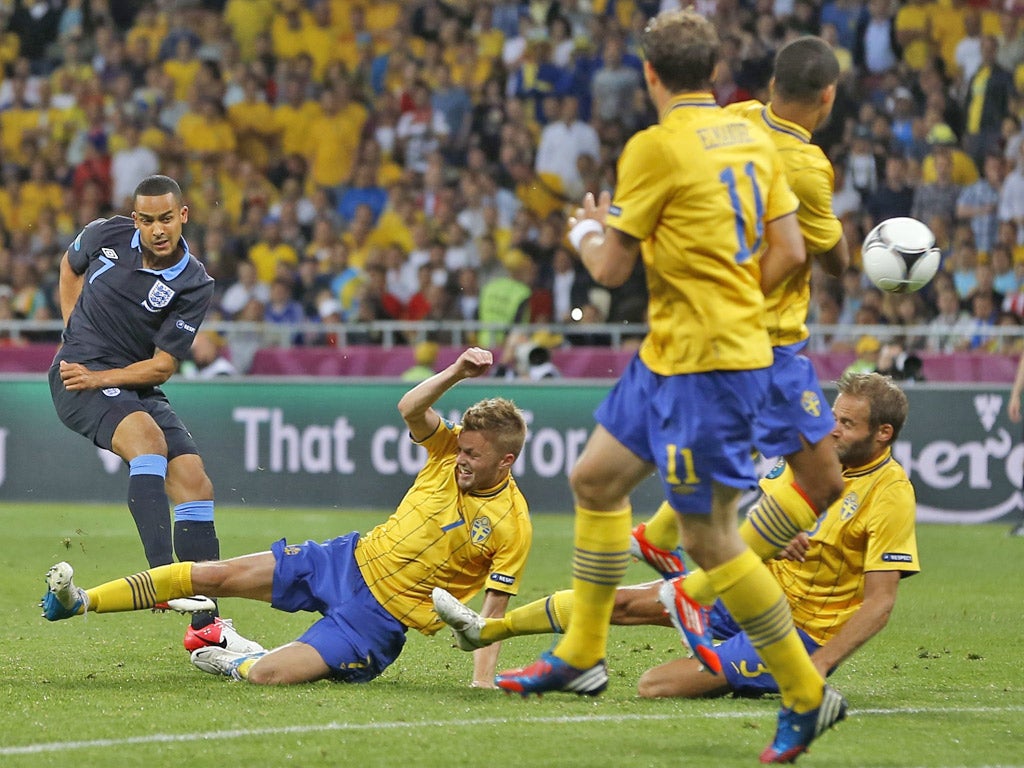 Theo Walcott fires home England's second goal against Sweden last night