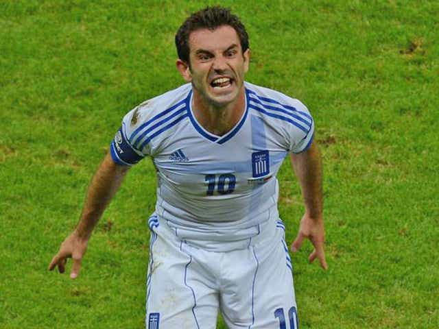Greek bail-out: Giorgos Karagounis celebrates the goal that helped to save his team from a European Championship exit in last night's win over Russia