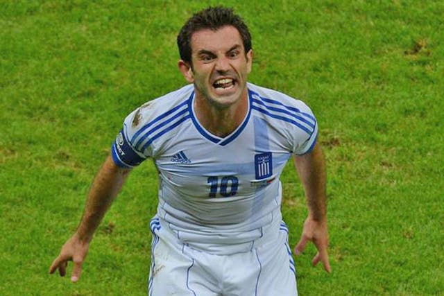 Greek bail-out: Giorgos Karagounis celebrates the goal that helped to save his team from a European Championship exit in last night's win over Russia