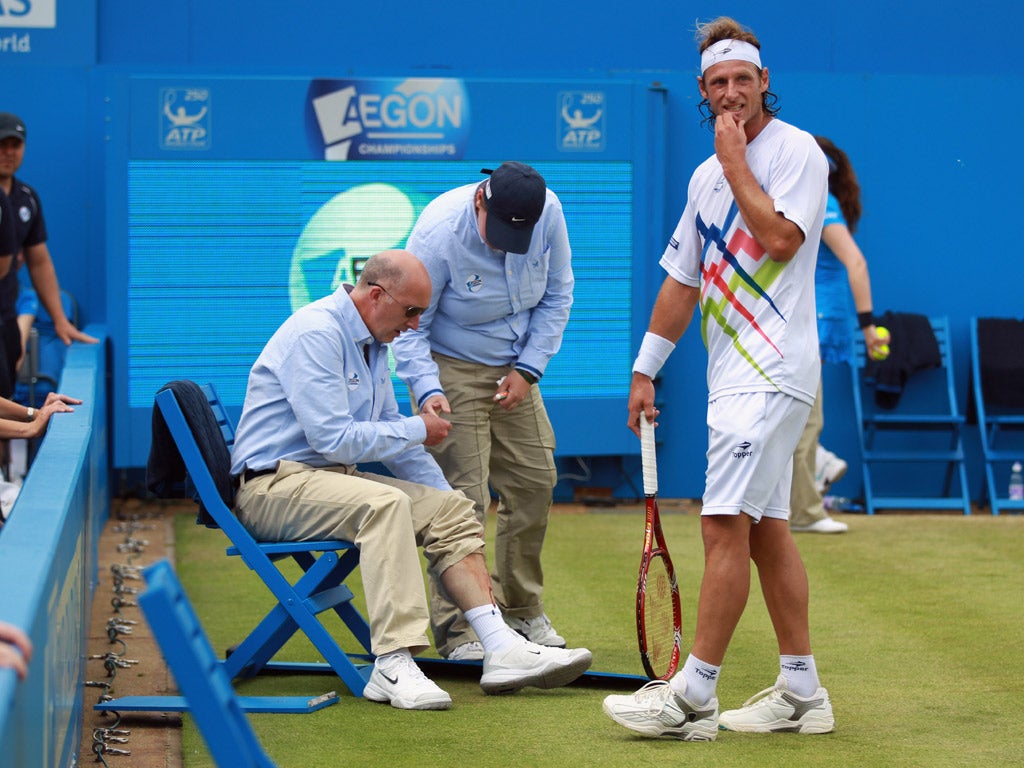 David Nalbandian was disqualified from the final at the Queen's Club after he kicked an advertising board which struck a line judge