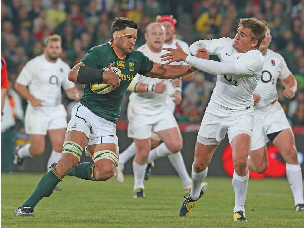 England’s Toby Flood (right) gets the brush off from Pierre
Spies on Saturday