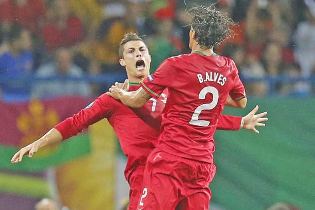 Cristiano Ronaldo (left) celebrates his second goal with Bruno Alves