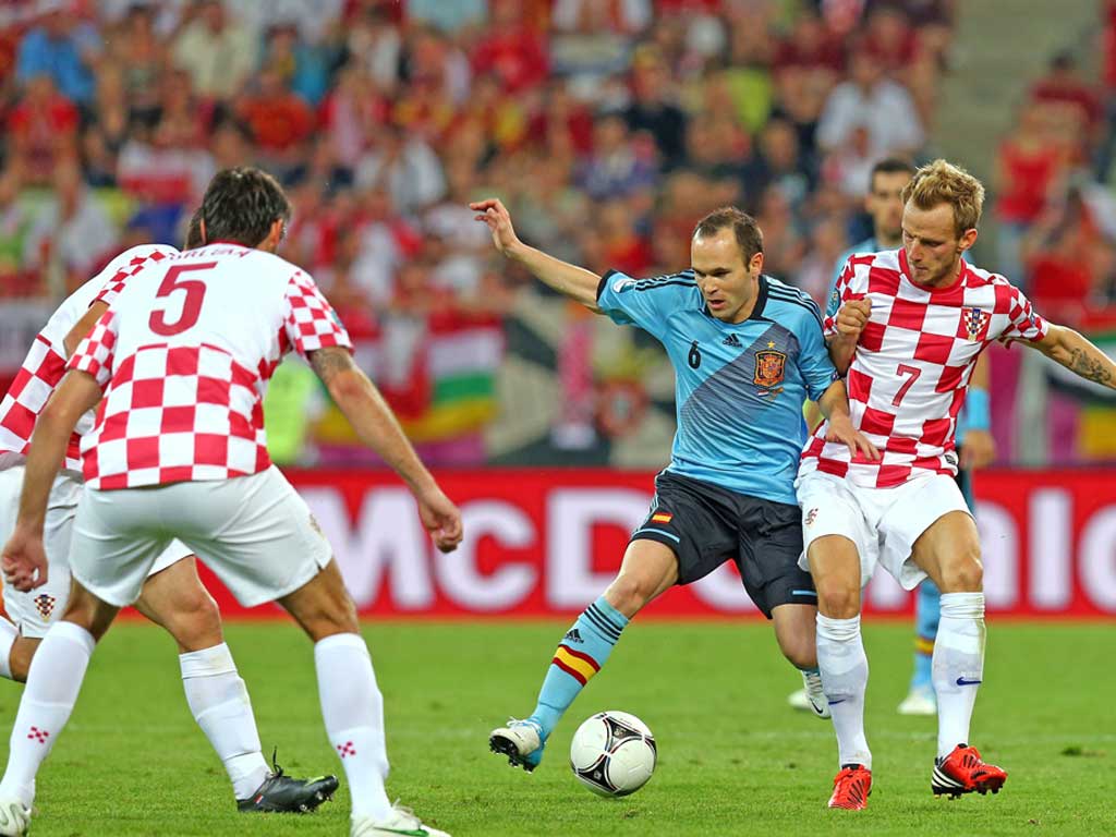 Andres Iniesta of Spain and Ivan Rakitic of Croatia compete for the ball during the UEFA EURO 2012 group C match