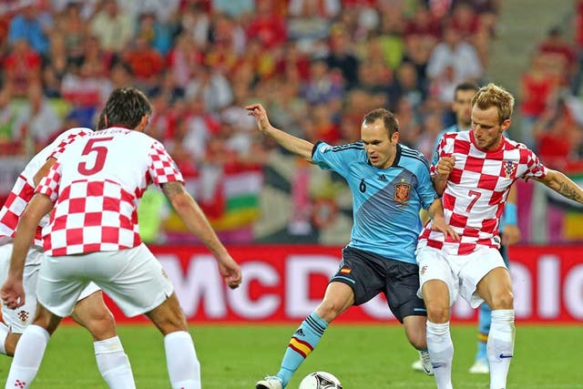 Andres Iniesta of Spain and Ivan Rakitic of Croatia compete for the ball during the UEFA EURO 2012 group C match