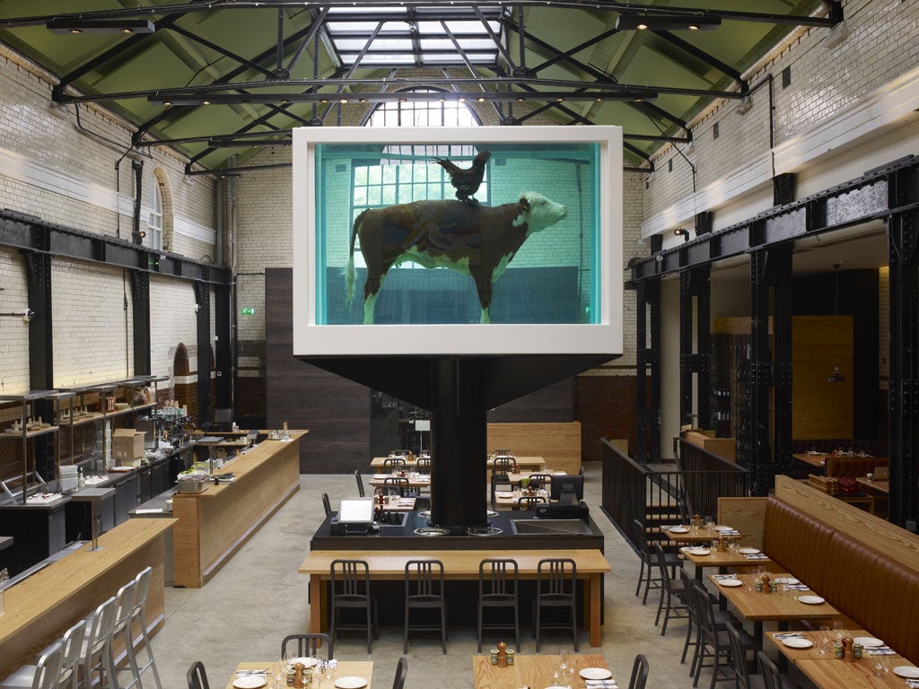 Dish of the day: The restaurant is dominated by an enormous Damien Hirst vitrine containing an embalmed cow being ridden by a cockerel