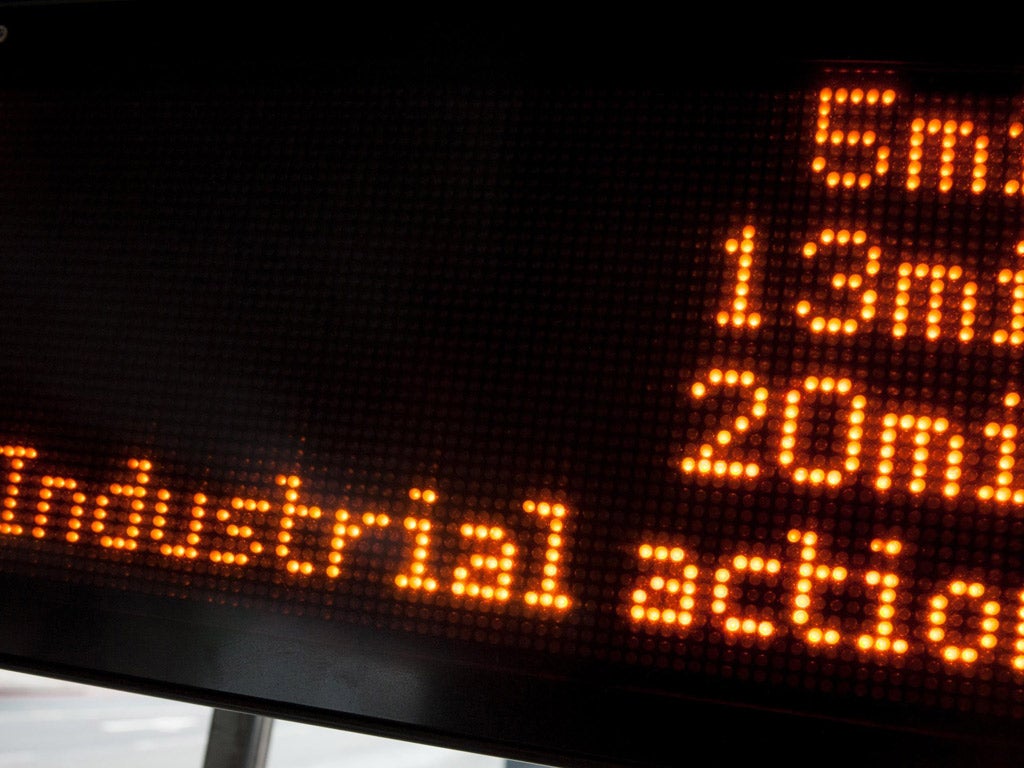 A digital display shows waiting times at a bus stop in south London, as industrial action by bus drivers in the city disrupts bus services